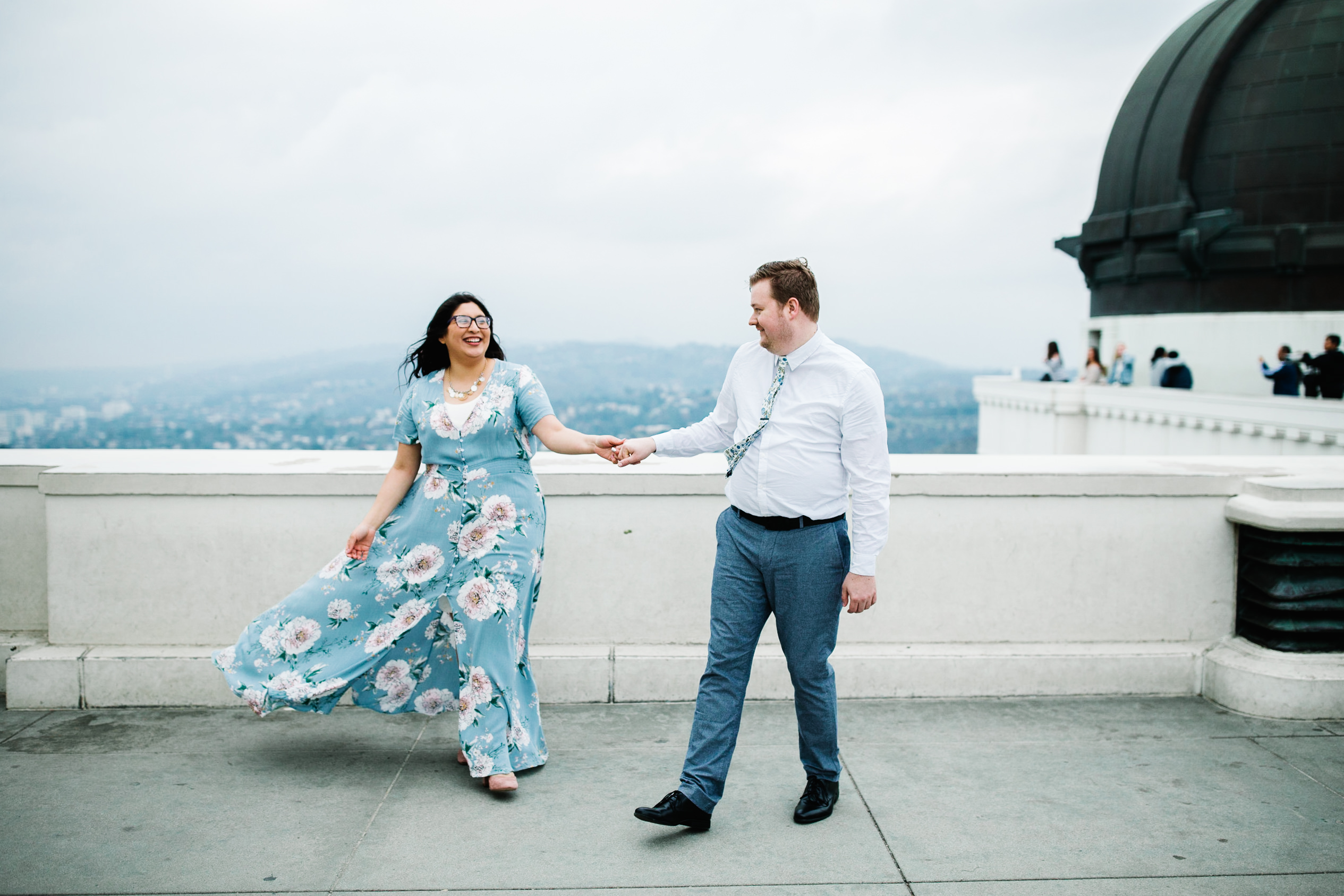 griffith observatory engagement photos Couple walking on roof deck at Griffith Observatory in Los Angeles , California.