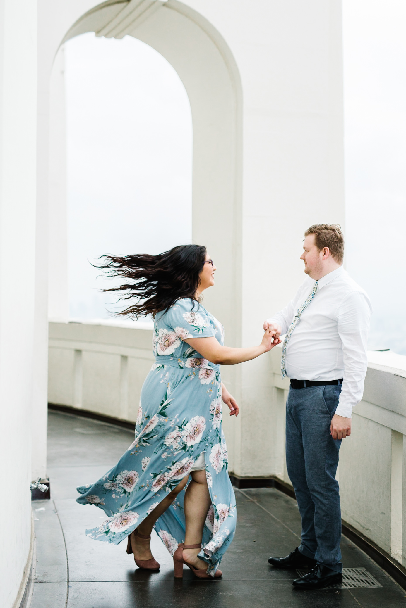 griffith observatory engagement photos bride twirling with groom at griffith observatory