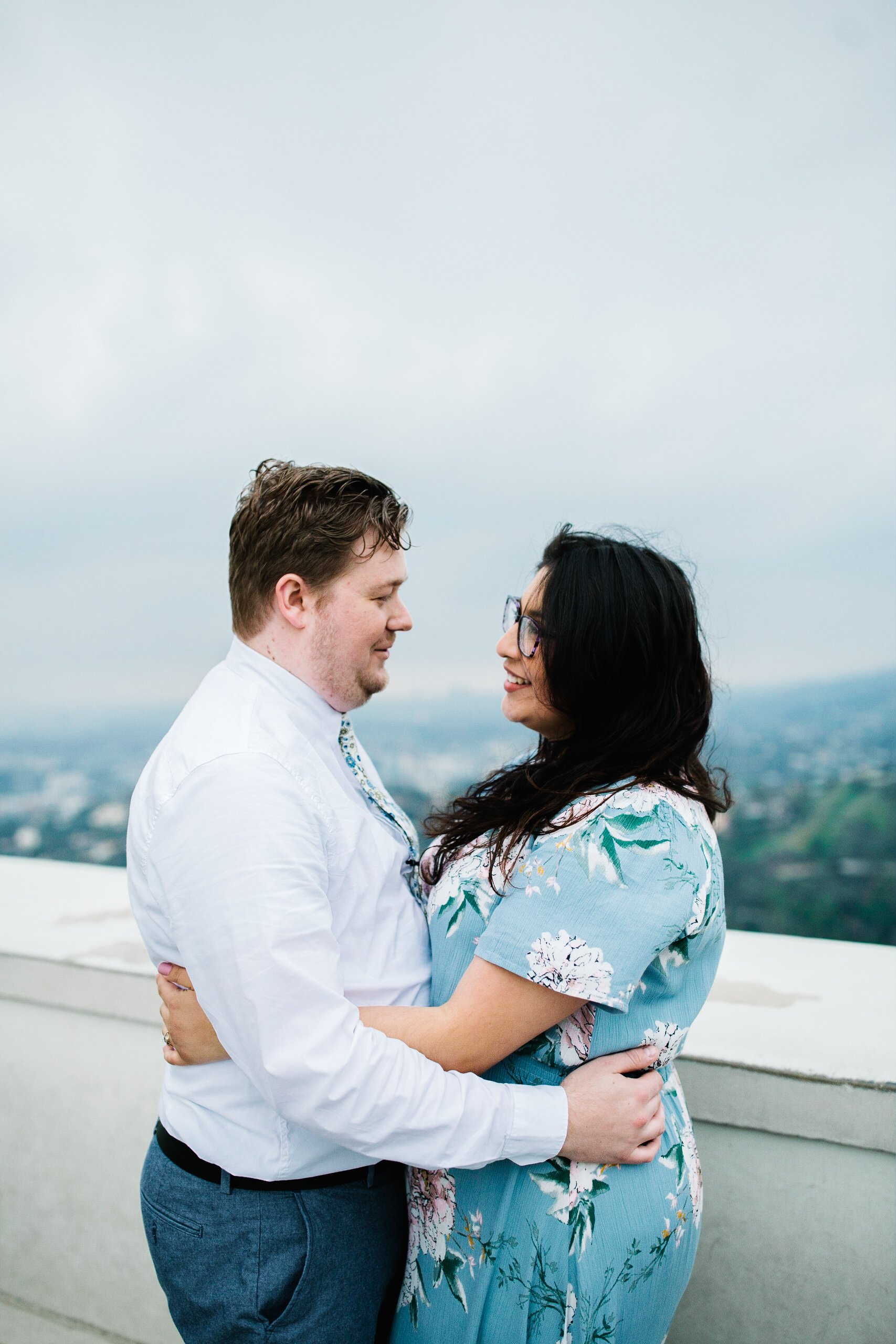 griffith observatory engagement photos Couple look each other in the eyes at Griffith Observatory in Los Angeles , California.