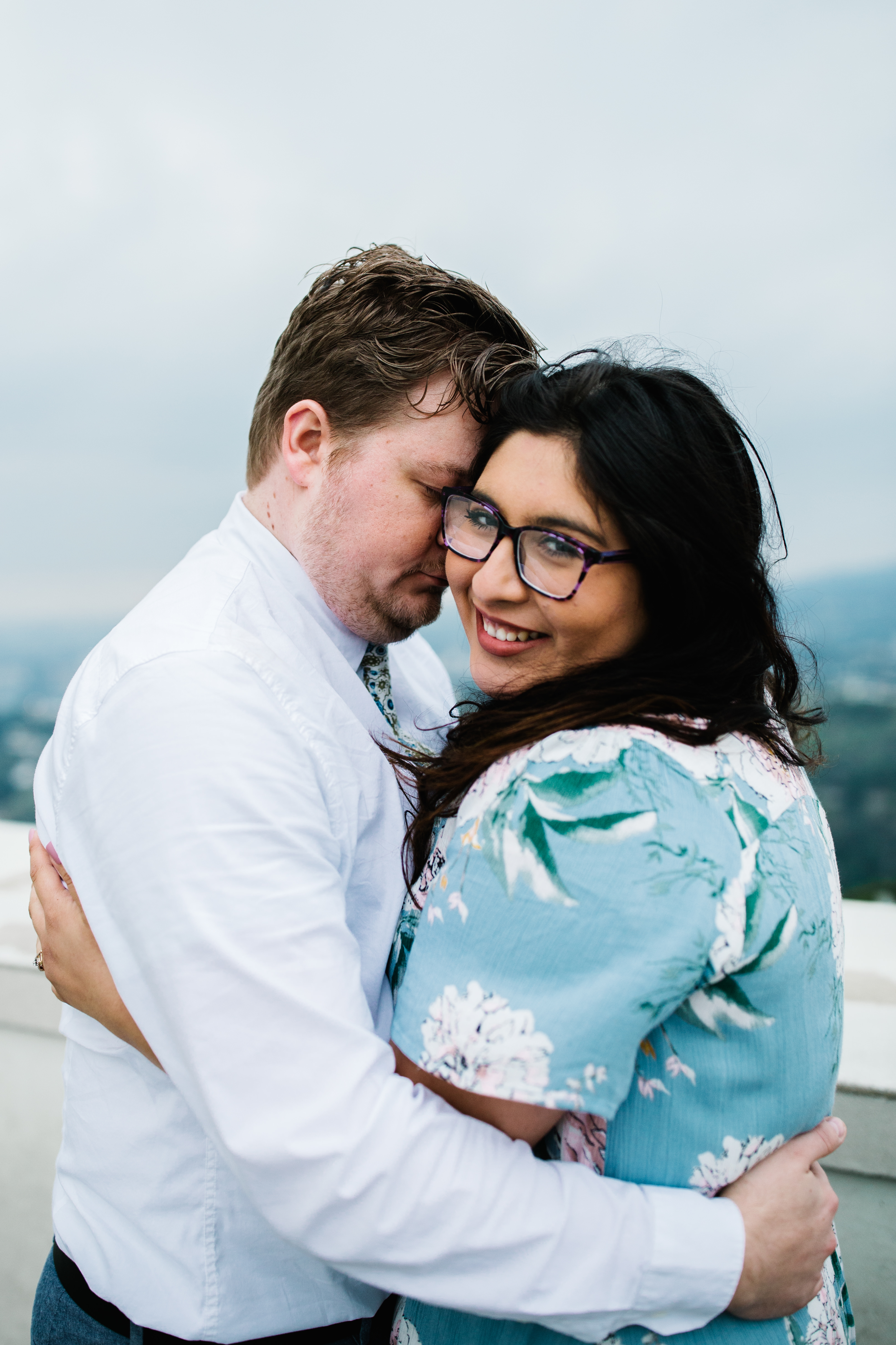 griffith observatory engagement photos Couple embrace at Griffith Observatory in Los Angeles , California.