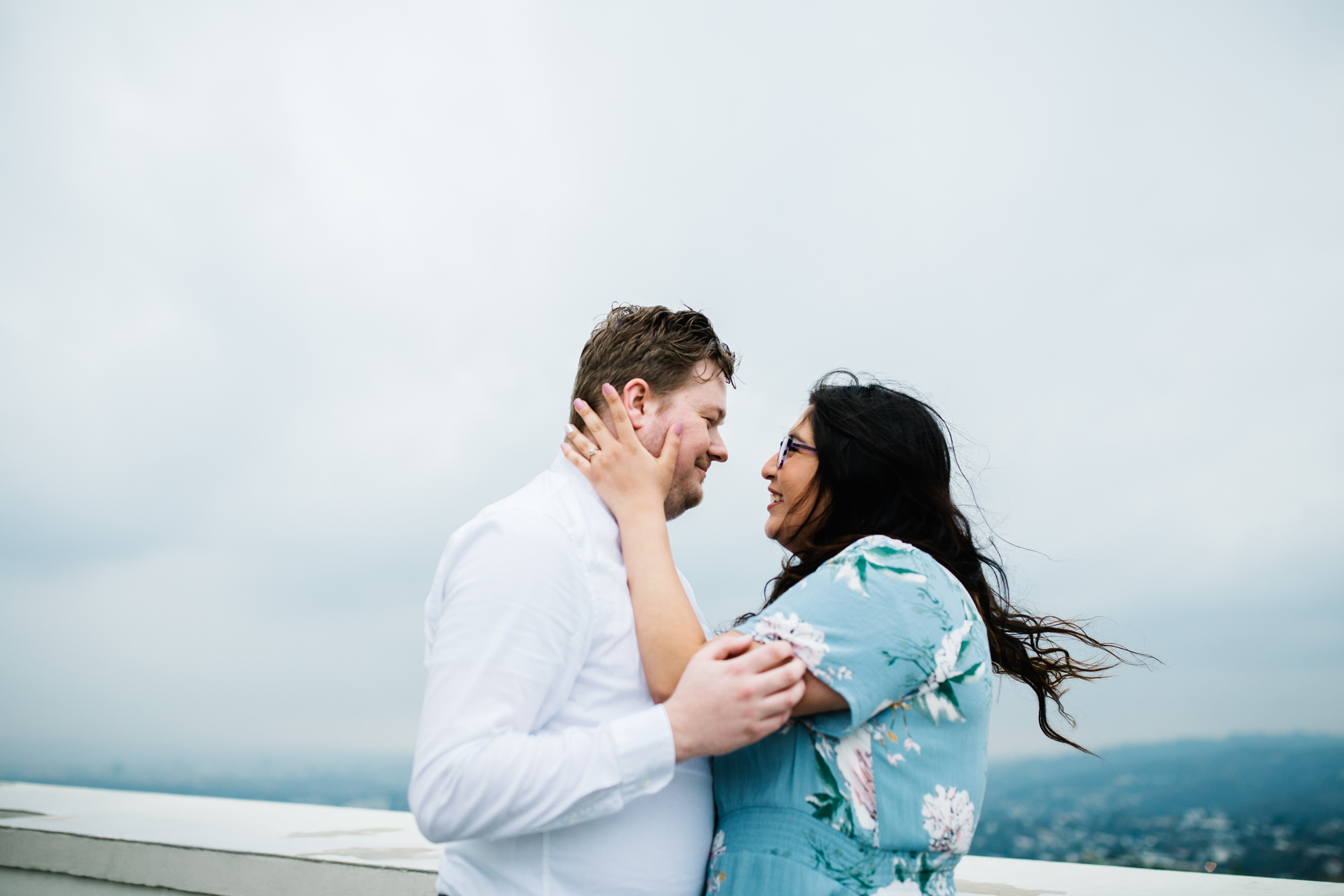 griffith observatory engagement photos Couple hold each other at Griffith Observatory in Los Angeles , California.