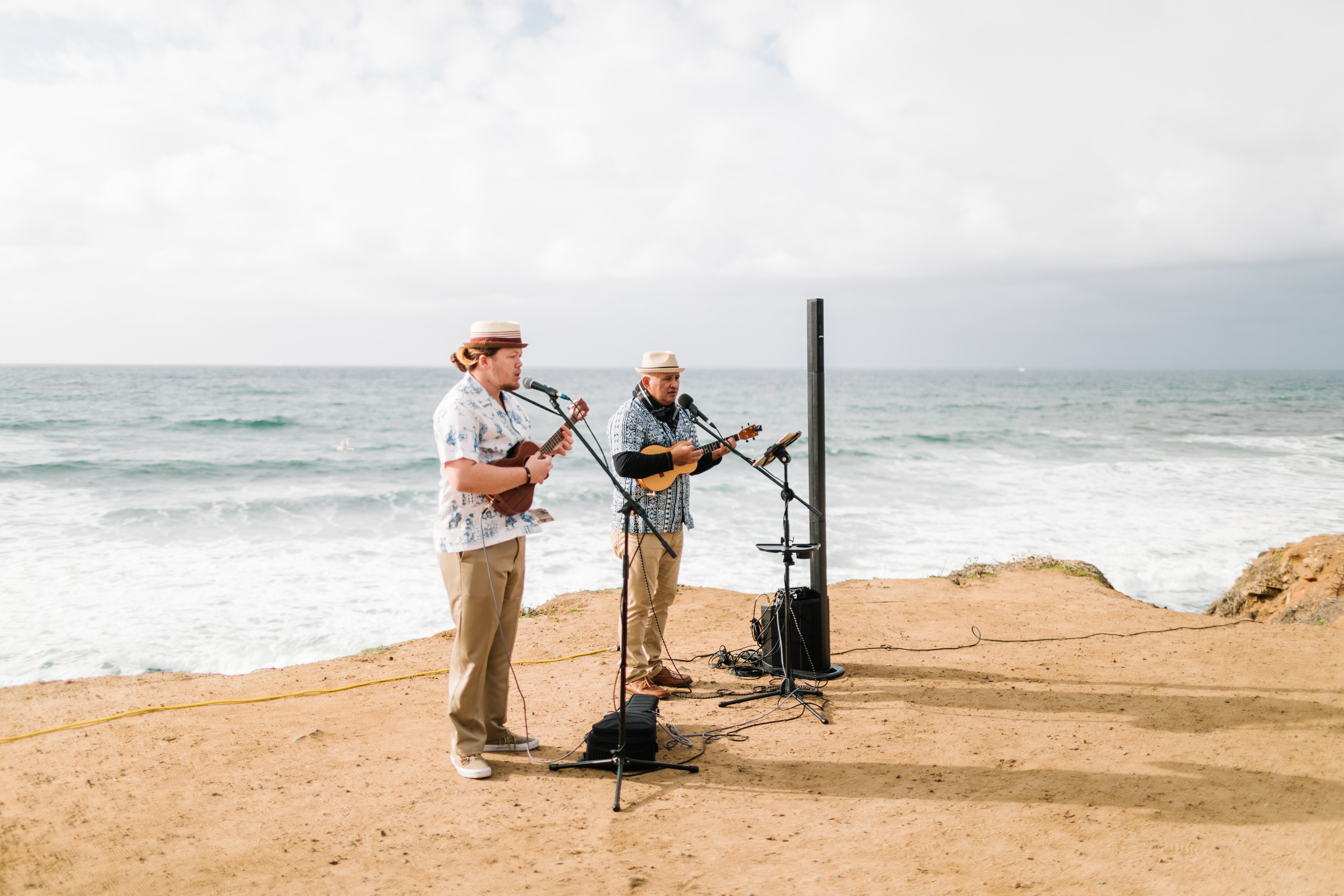 ukulele players on cliffside at sunset cliffs wedding