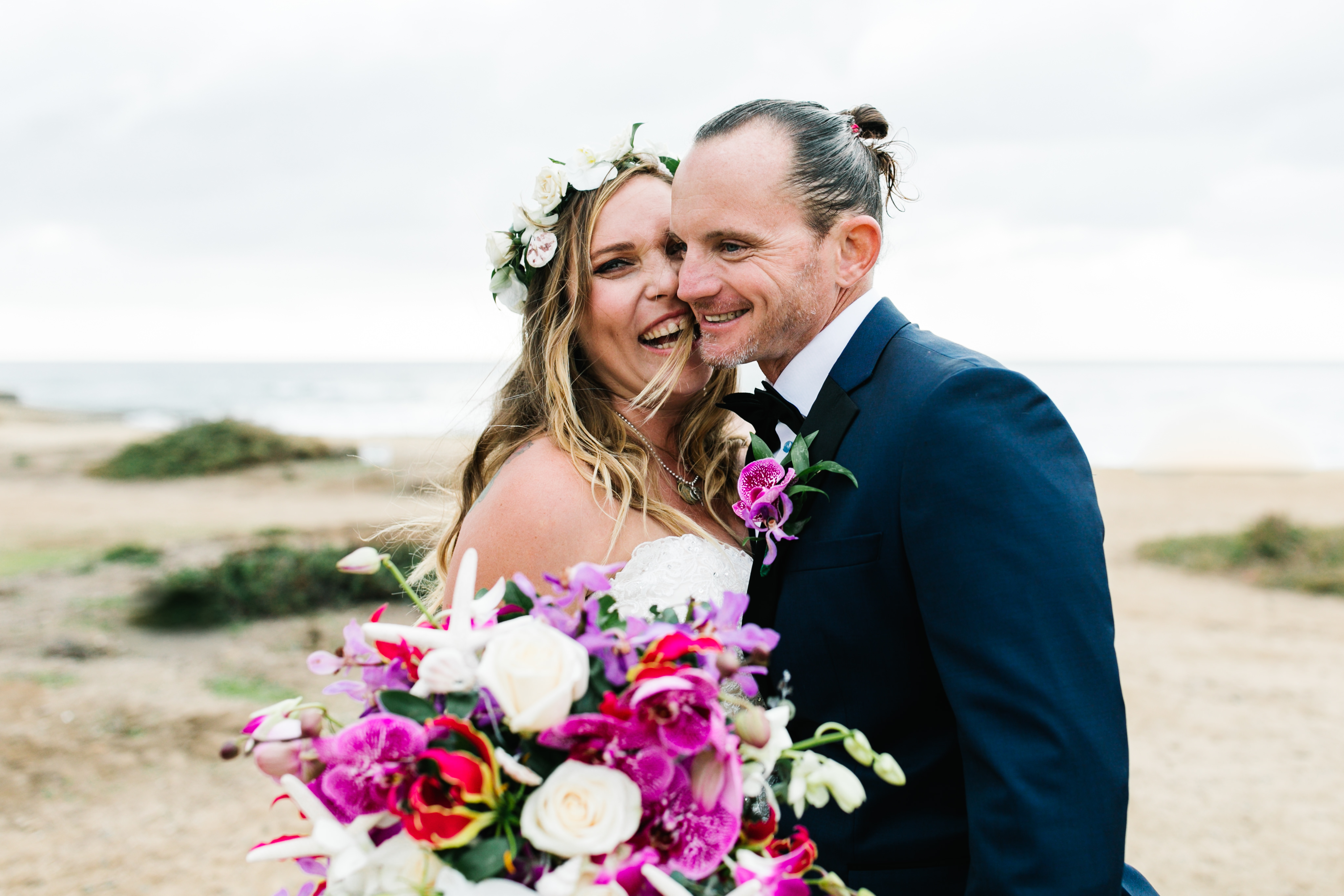 bride and groom excited at beach at sunset cliffs wedding