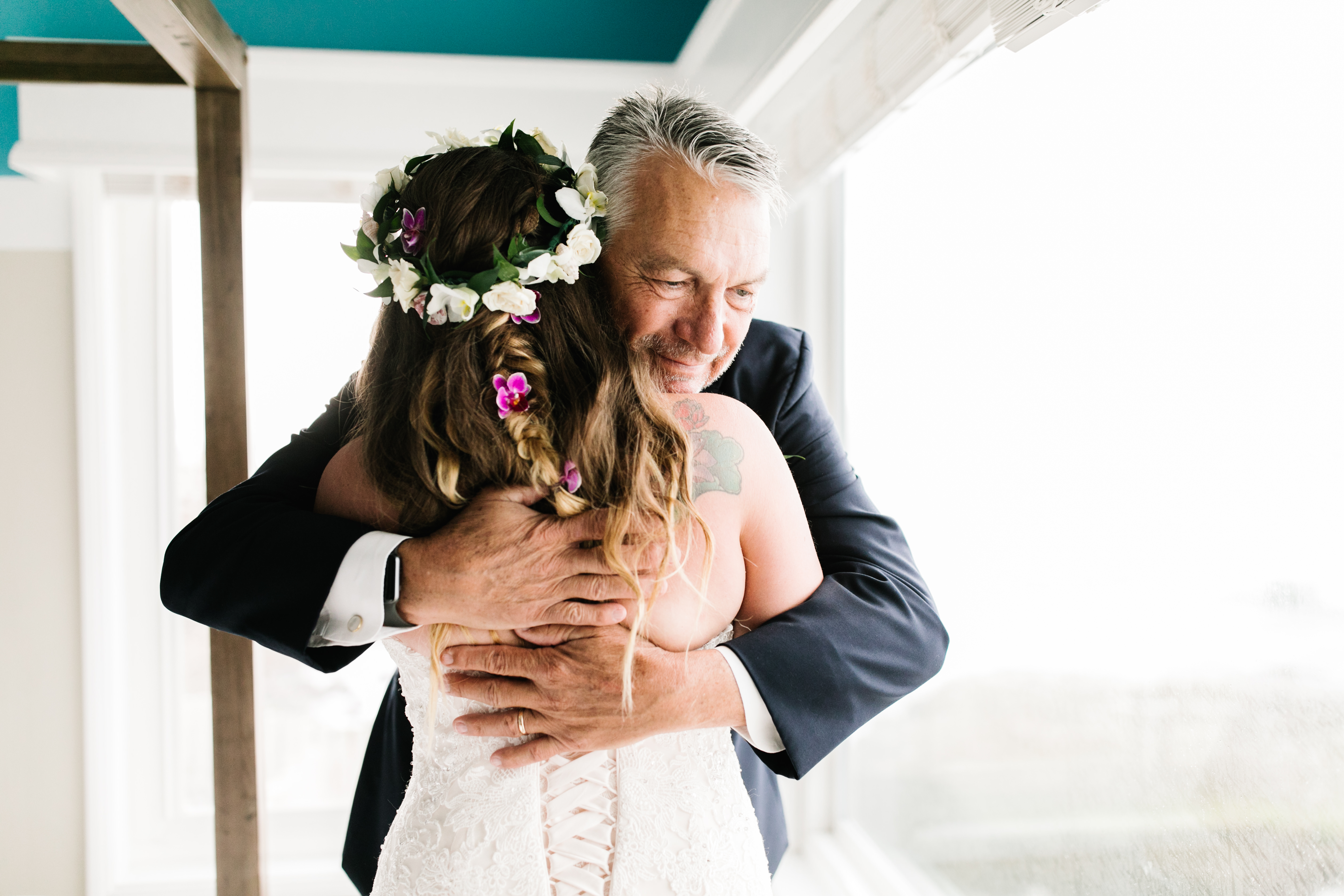 father of bride hugging daughter sunset cliffs wedding