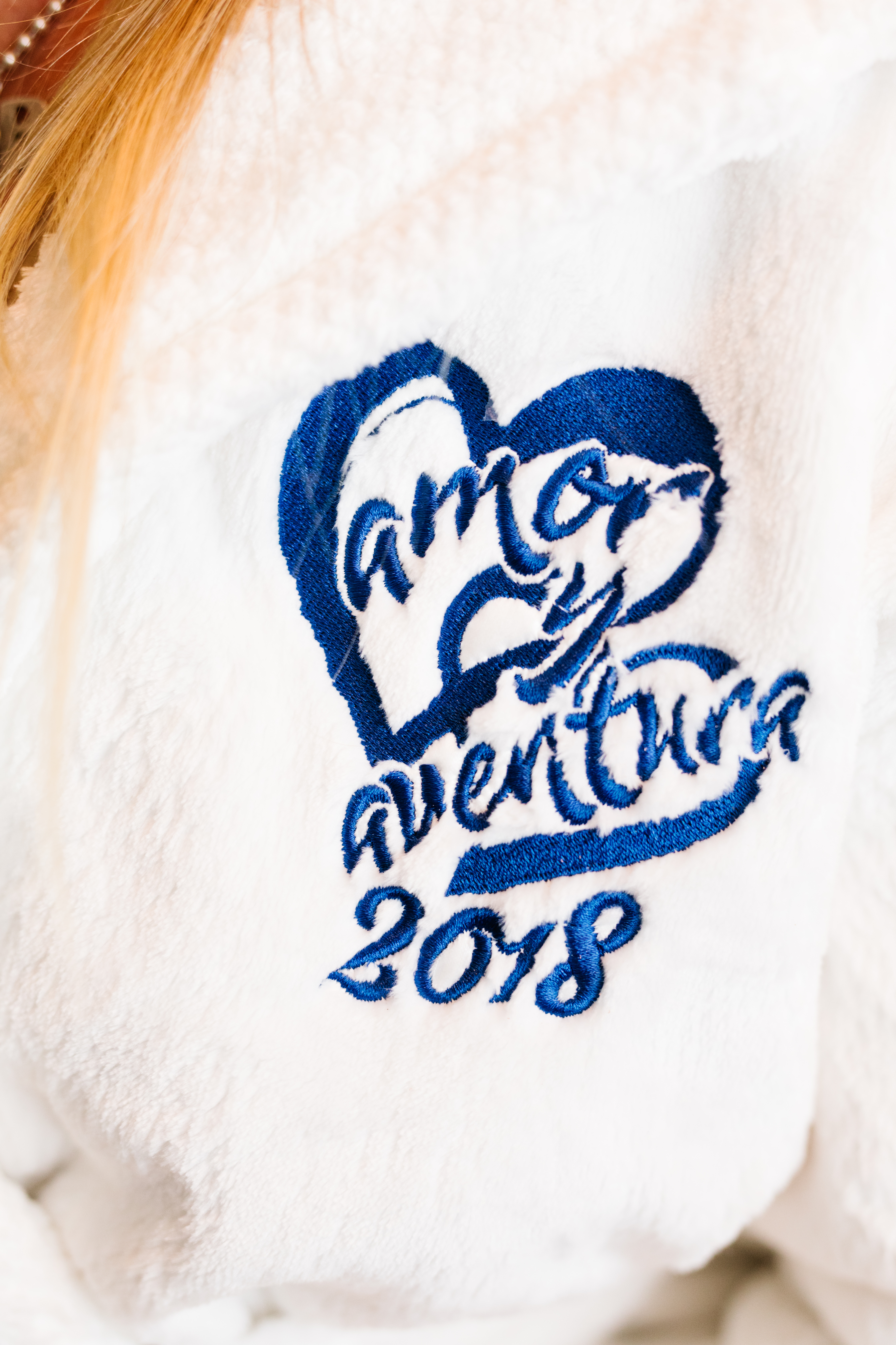 Wedding logo "amor y aventura" on white robe sunset cliffs wedding