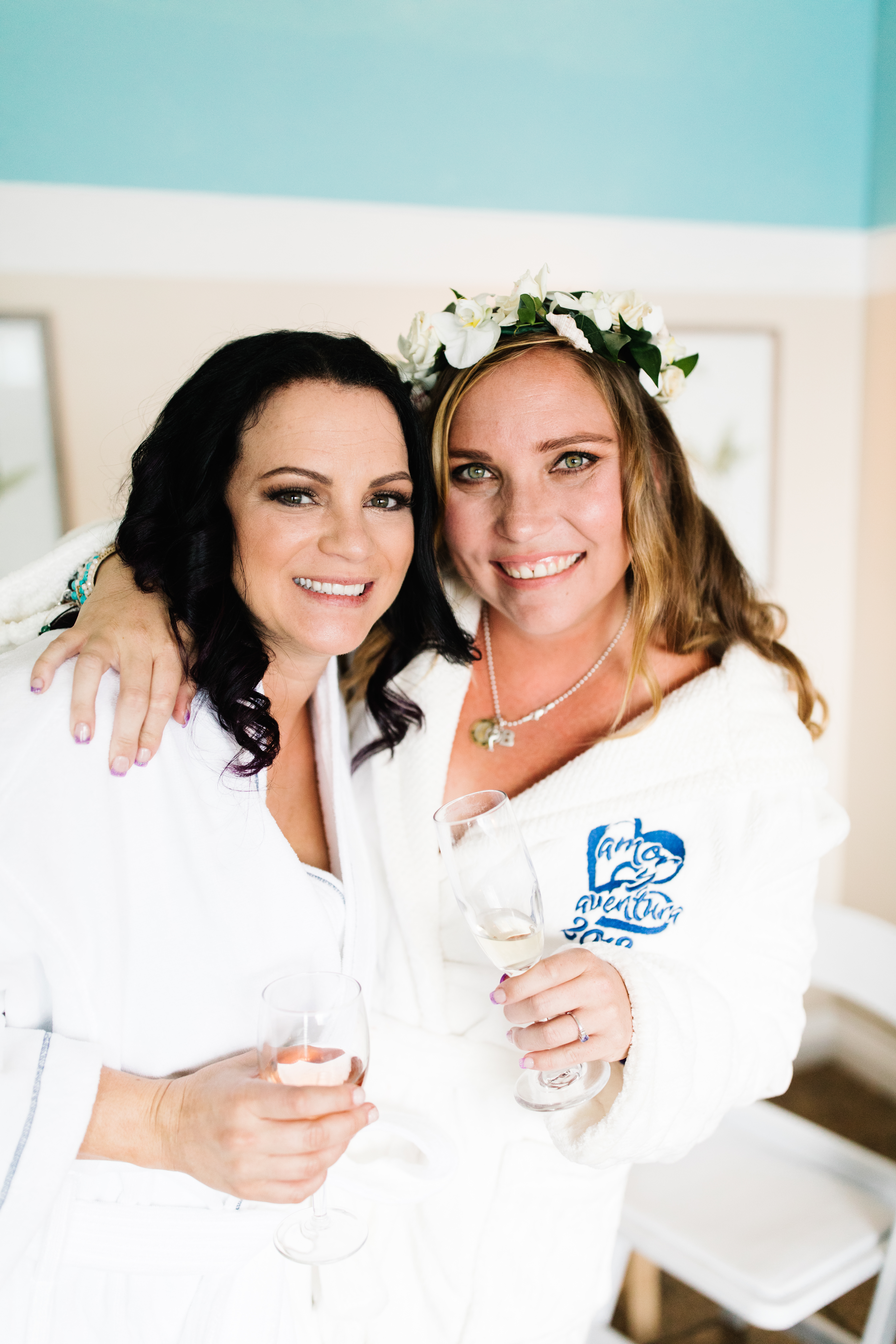 bride and bridesmaid in getting ready robes smiling sunset cliffs wedding