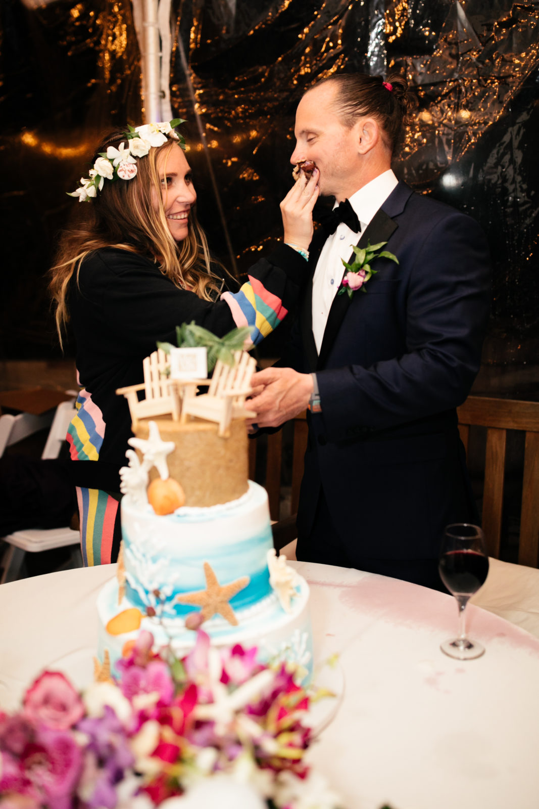 bride feeding groom cake at sunset cliffs wedding