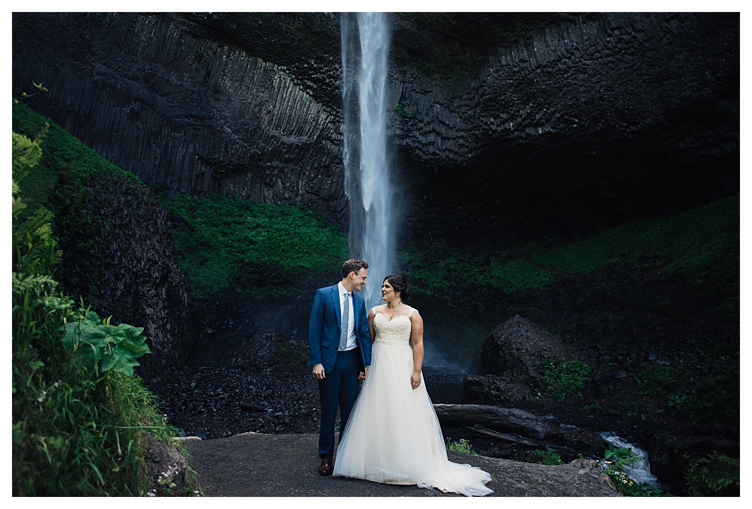 bride and groom with giant waterfall