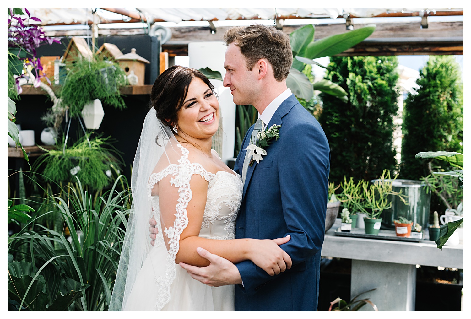 wedding couple laughing in greenhouse