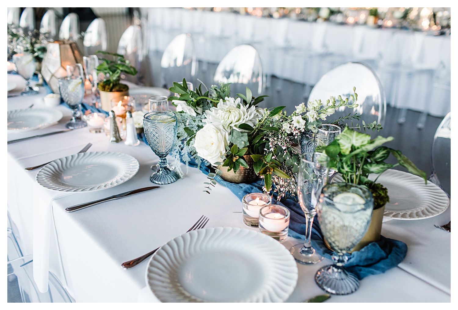 wedding table setting with greenery and blue accents
