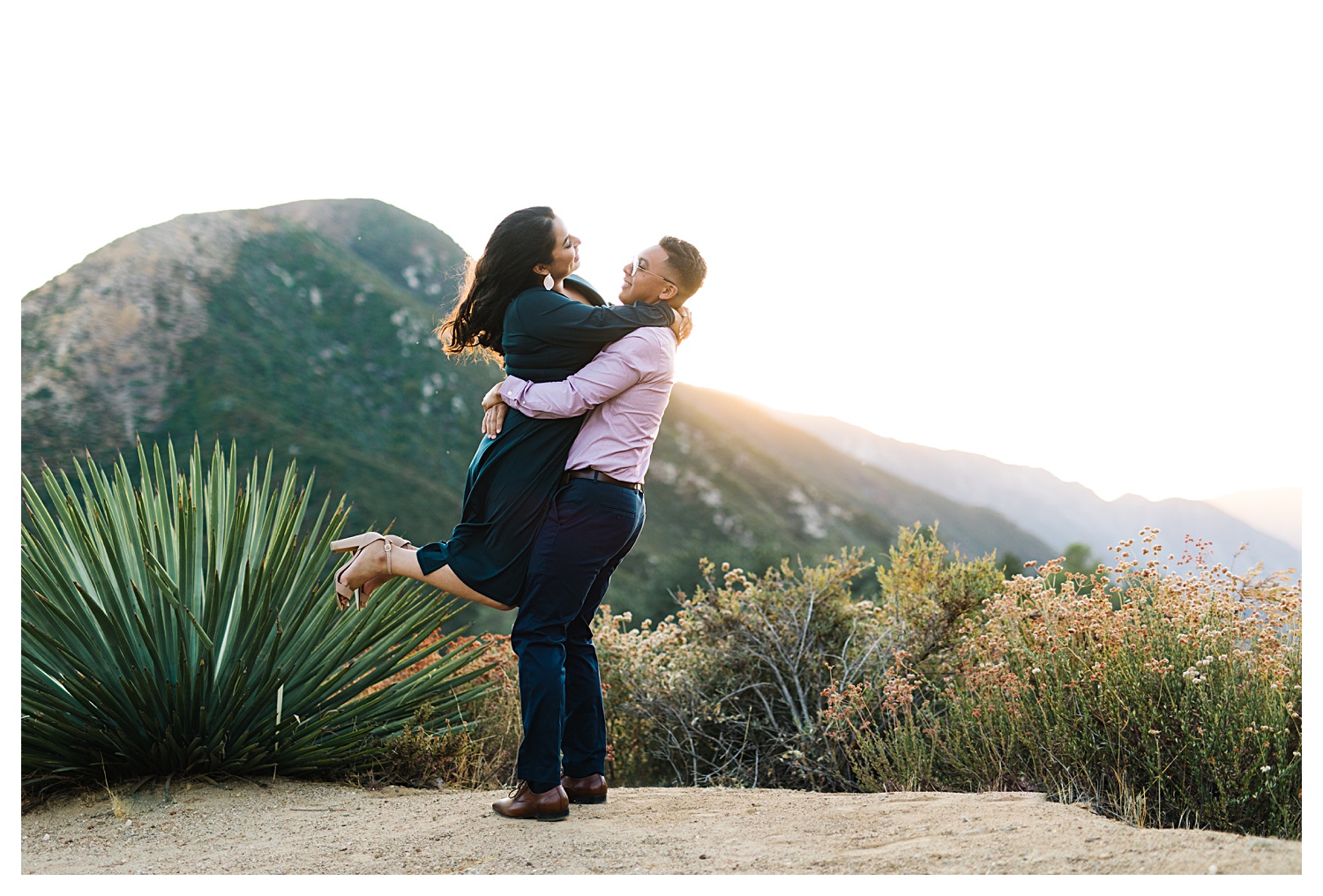 Angeles National Forest Engagement Photos guy spinning girl with mountains in background