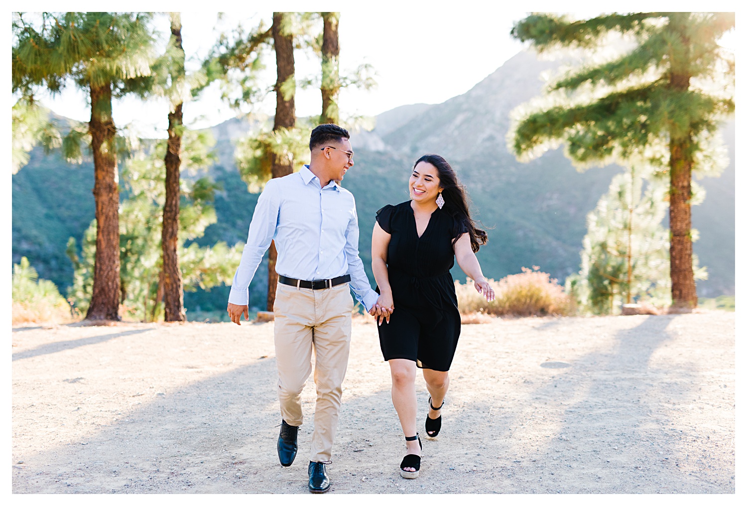 Angeles National Forest Engagement Photos couple running in forest together