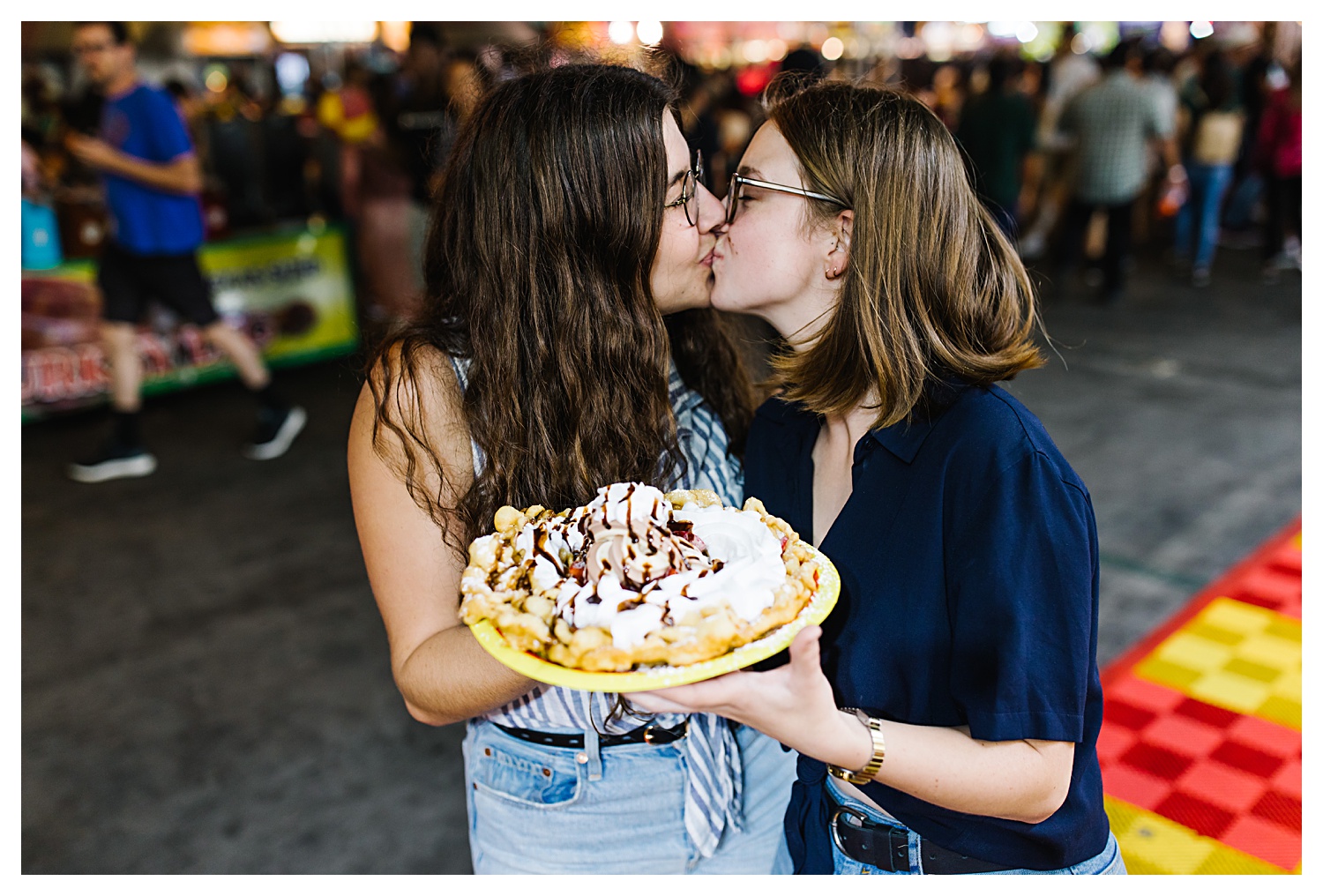 couple kissing at oc fair couples photos holding funnel cake