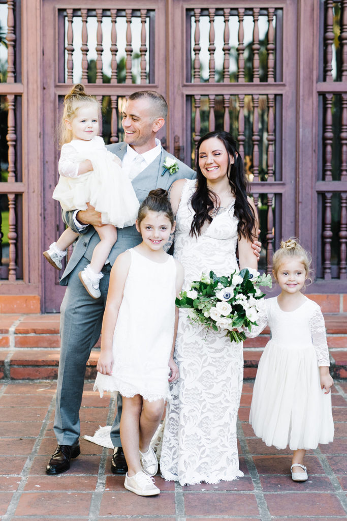 wedding photo of flower girls with married couple