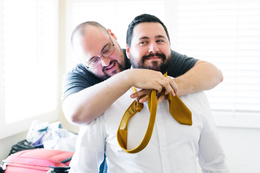 groomsmen tying tie