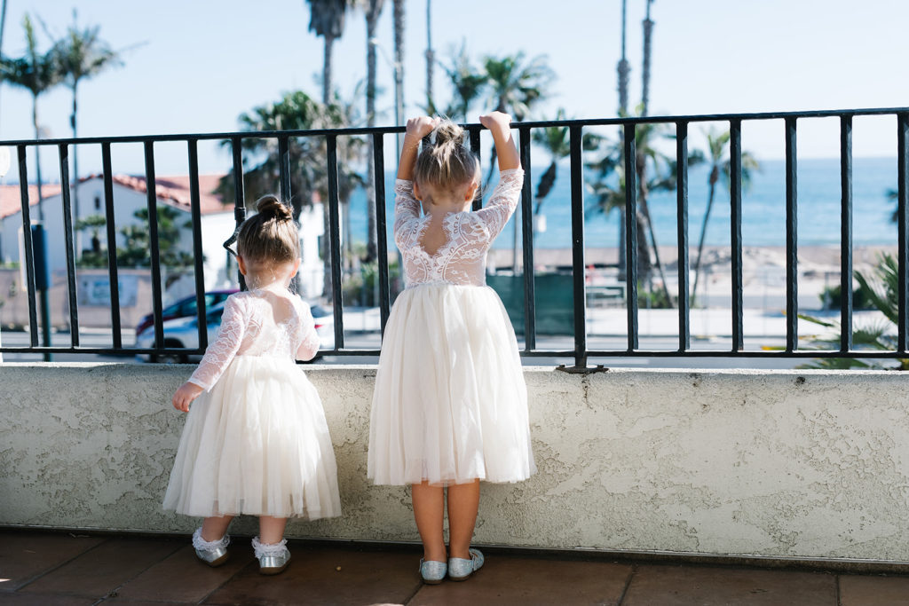 flower girls look out from balcony